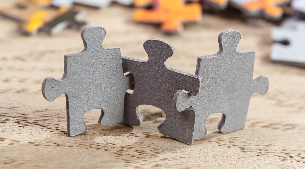 Three Jigsaw Puzzle Pieces on Table