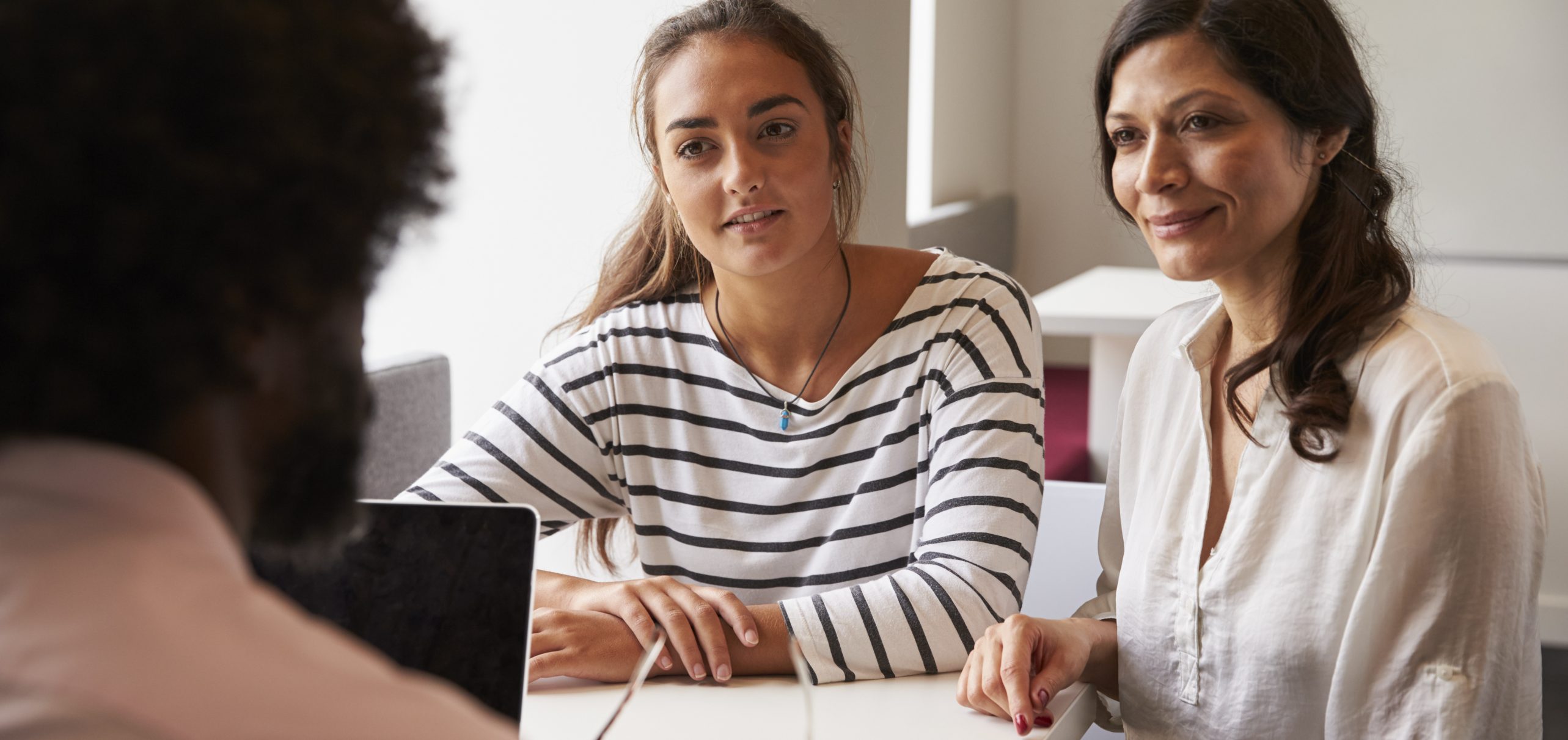 Mother And Daughter Meeting With Male Teacher