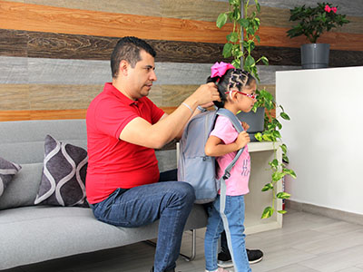 Father helping young daughter with her hair
