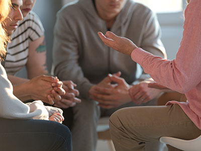 Group of people sitting and talking to each other in a circle