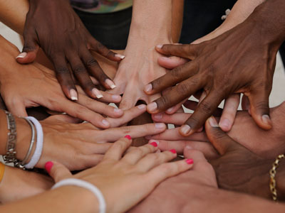 Diverse group of hands in a huddle