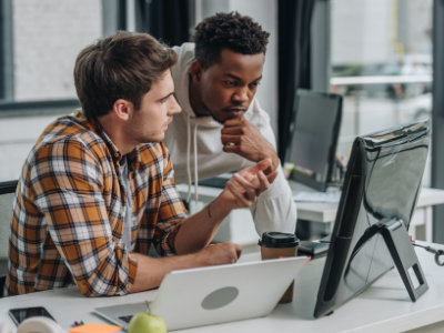 Two men looking at computer monitor