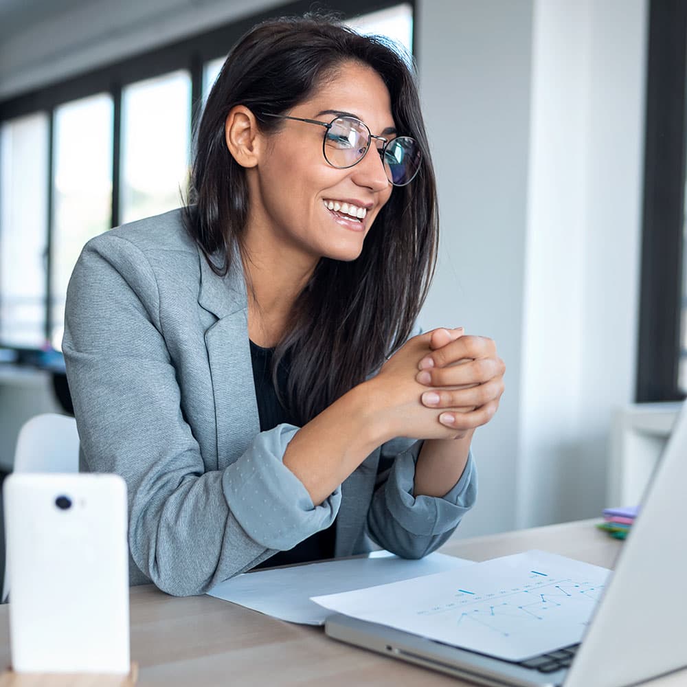 Businesswoman looking and speaking through computer's webcam