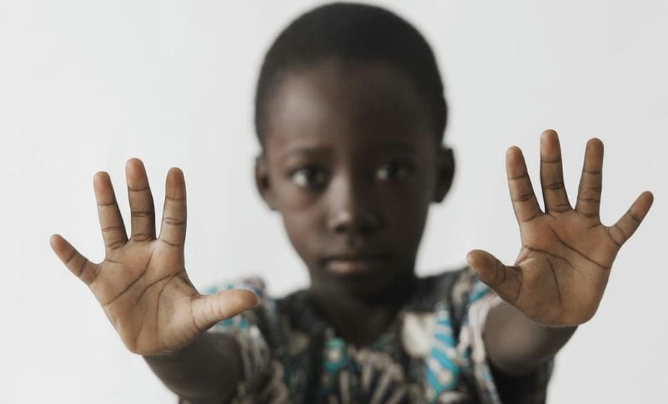 Child putting his hands out, indicating to stop