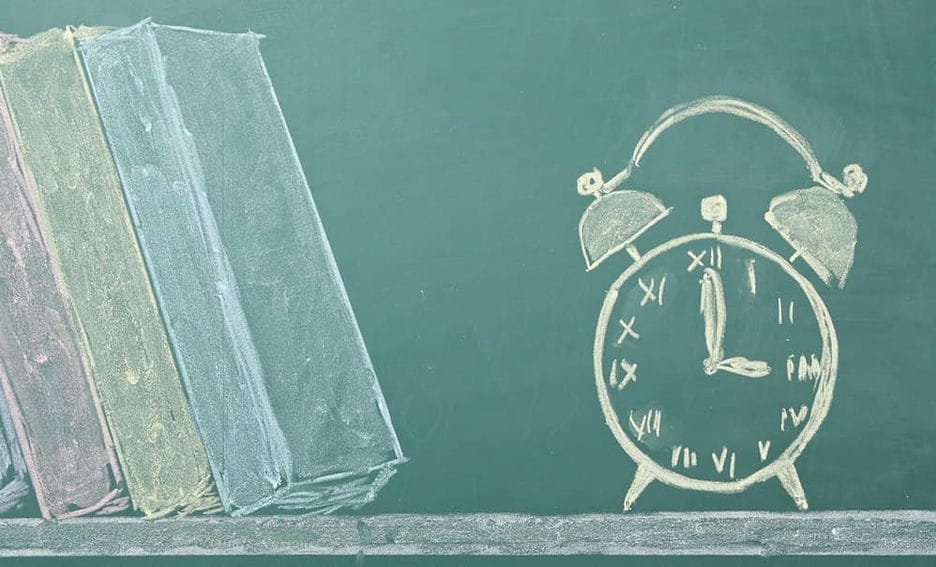 Chalk board illustration of an alarm clock and books
