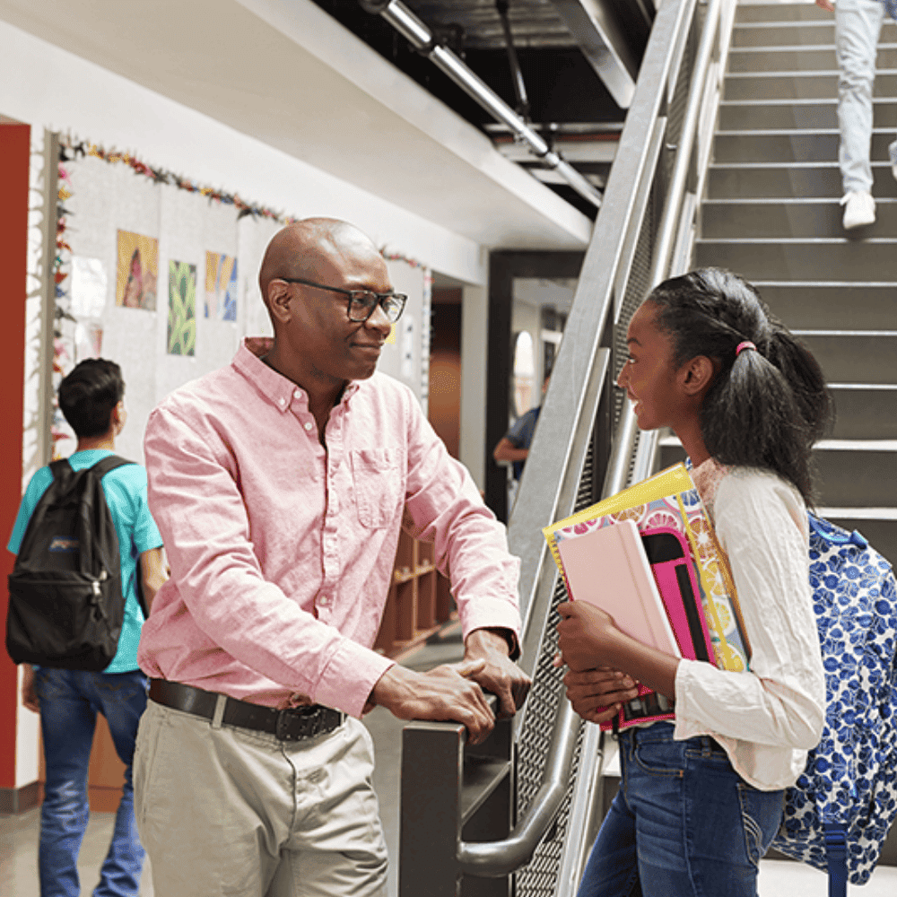 K-12 School Teacher engaging in conversation with a student