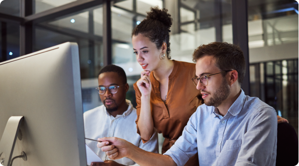 IT leaders two men and a woman looking thoughtfully at a screen and discussing what they see K-12 IT leaders in action - 3 Key Takeaways from CoSN2025: Why IT Leaders Are K-12 Power Players
