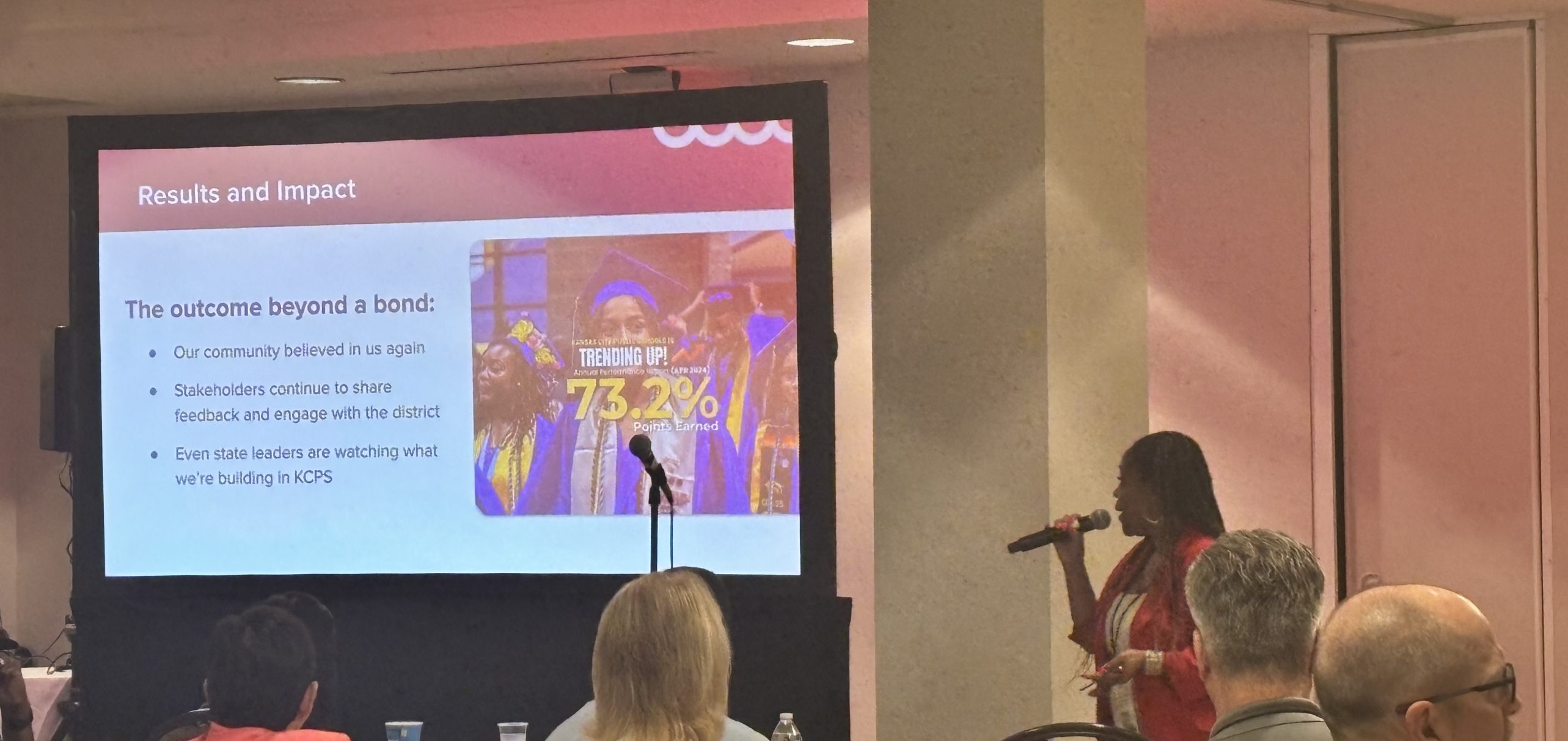 Dr Collier superintendent of Kansas City Public Schools give a presentation with a screen showing a title Results and Impact